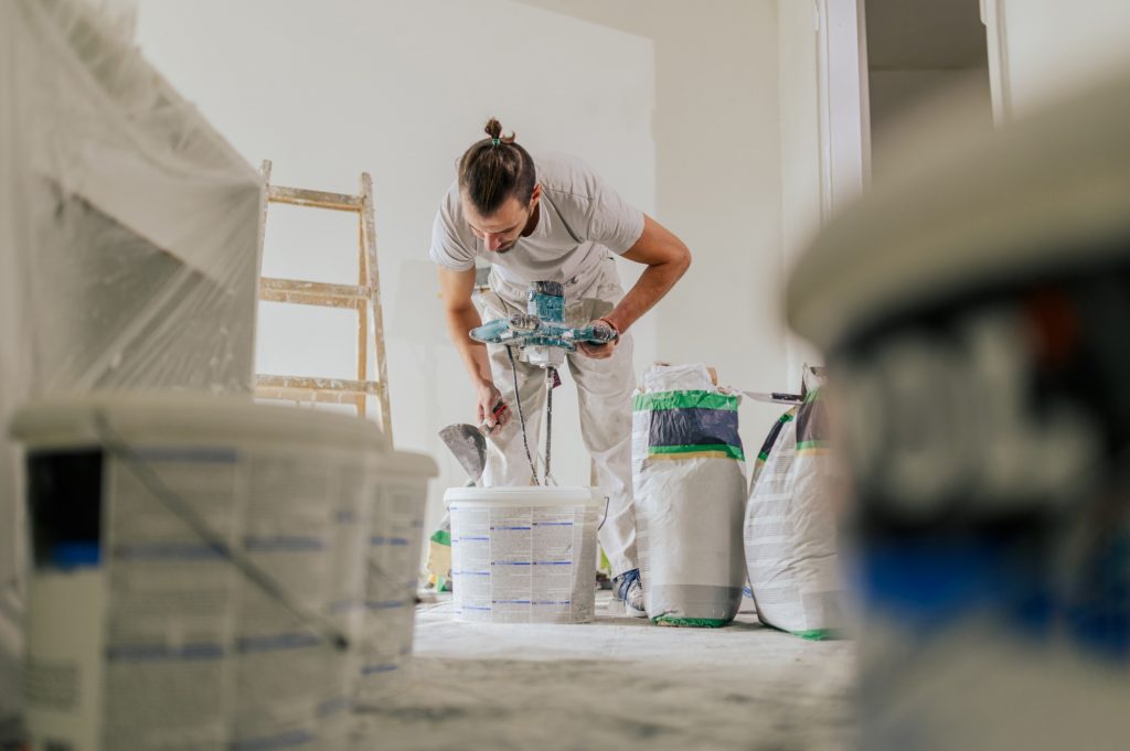 A plasterer is preparing materials for renovation a house.