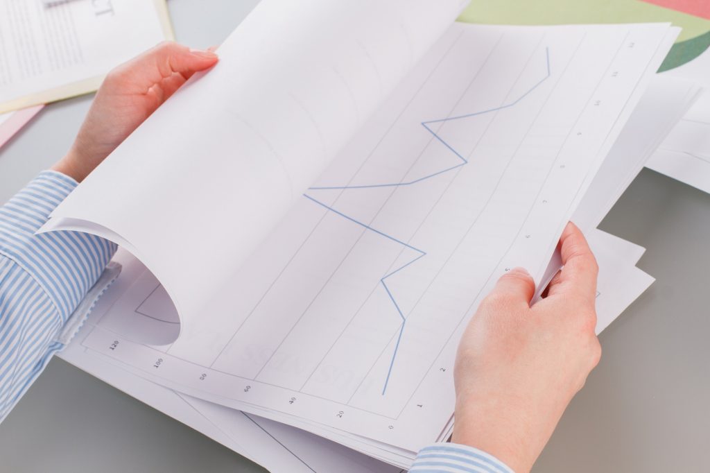 Business woman hands working with charts and diagrams.